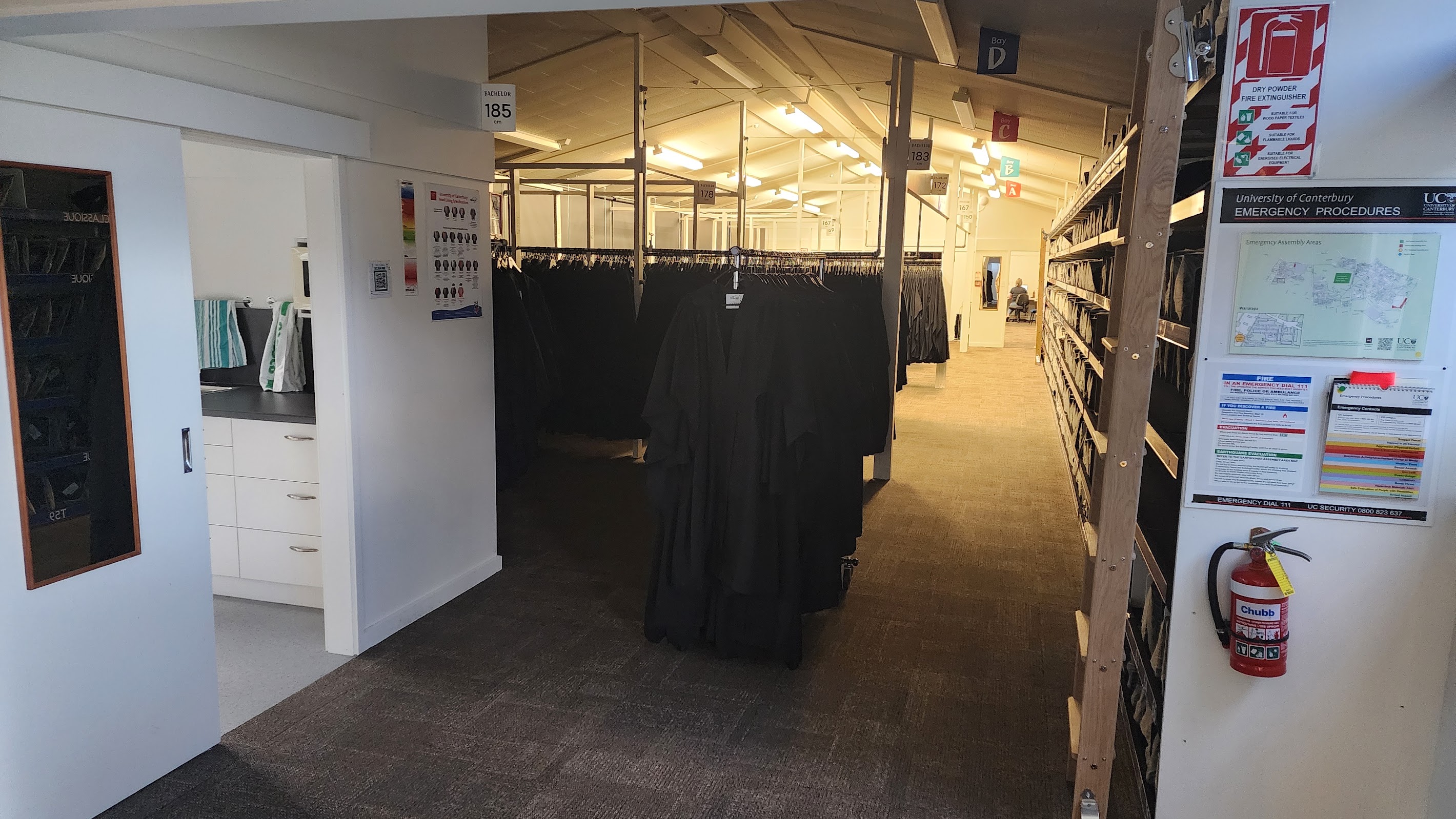 Graduation robes hanging in a regalia storehouse.